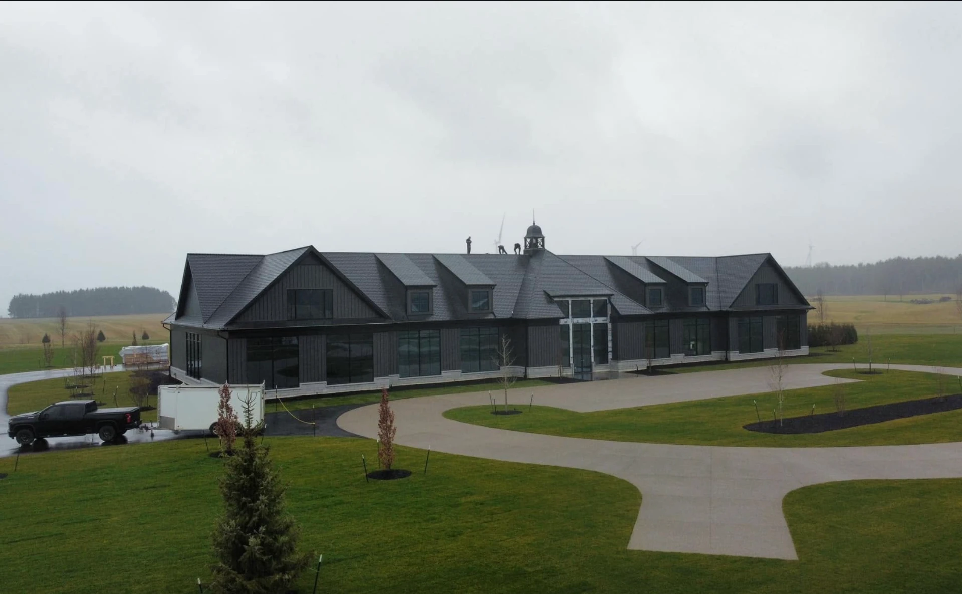 Black Onyx Construction crew finishing the roof of a large black commercial build in Elgin County, Ontario